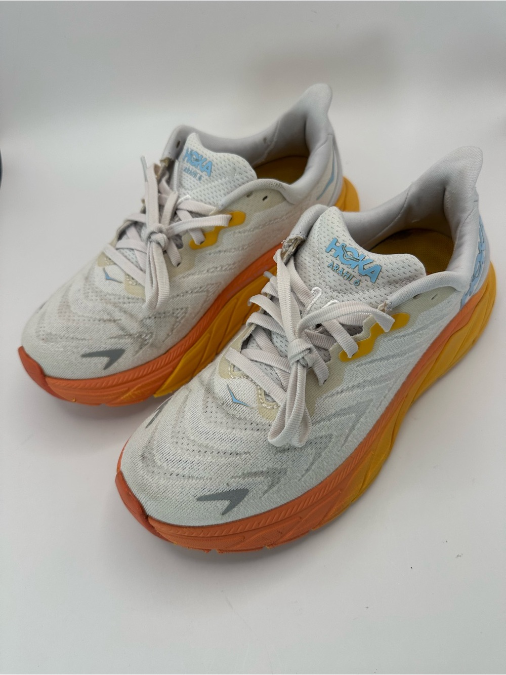 Hoka Neutral Cream Running Shoes with Orange and Yellow Midsole